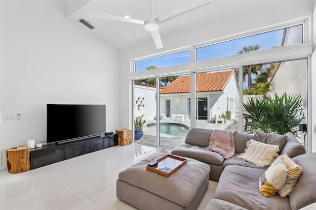living room with visible vents, ceiling fan, tile patterned flooring, and high vaulted ceiling