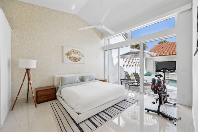bedroom featuring wallpapered walls, baseboards, lofted ceiling, and access to exterior