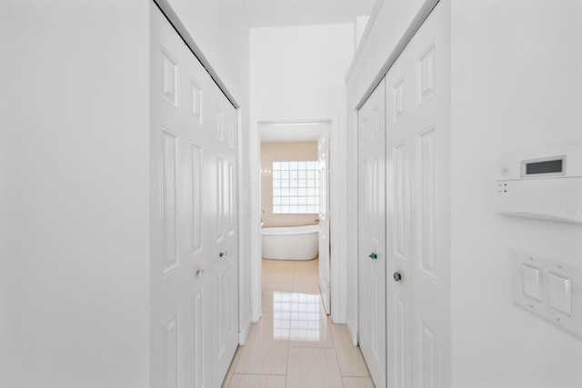 hall with light tile patterned flooring