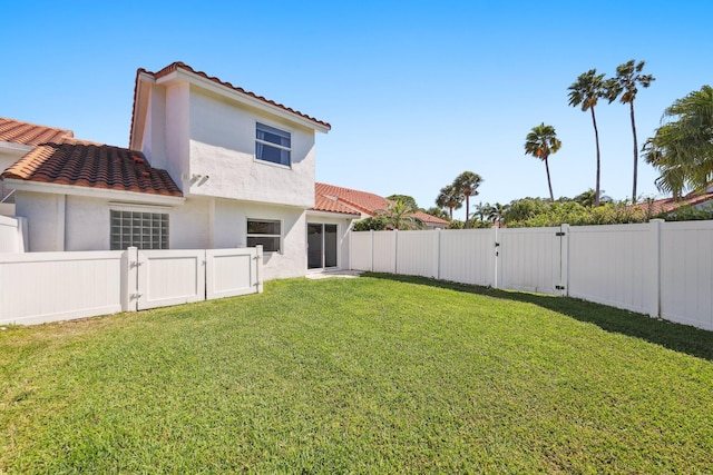 view of yard with a gate and a fenced backyard
