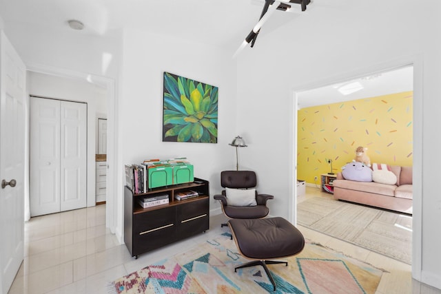 living area with tile patterned flooring and baseboards