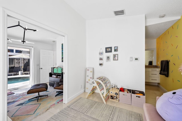 interior space with visible vents, baseboards, and light tile patterned flooring