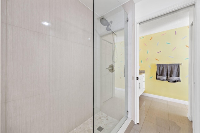 bathroom with vanity, tile patterned flooring, and tiled shower