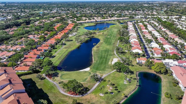 bird's eye view with a water view, view of golf course, and a residential view