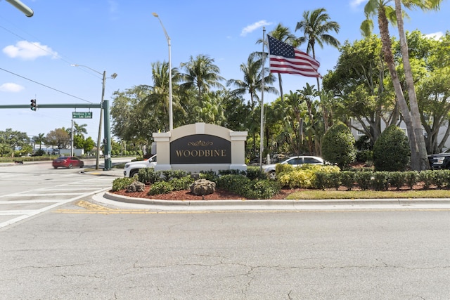 community sign featuring uncovered parking
