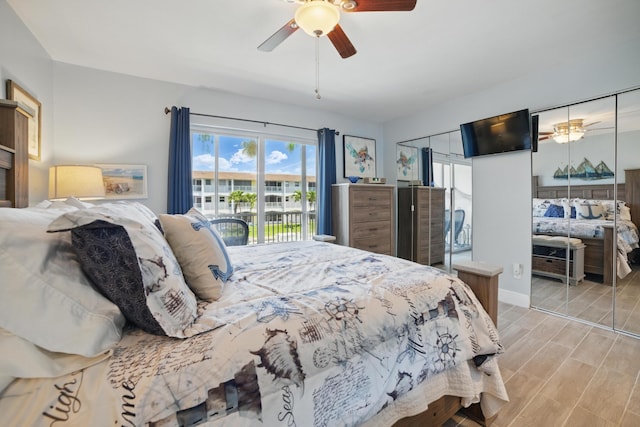 111 Doolen Ct Unit 208, North Palm Beach, FL 33408 - bedroom with wood tiled floors, access to outside, and a ceiling fan