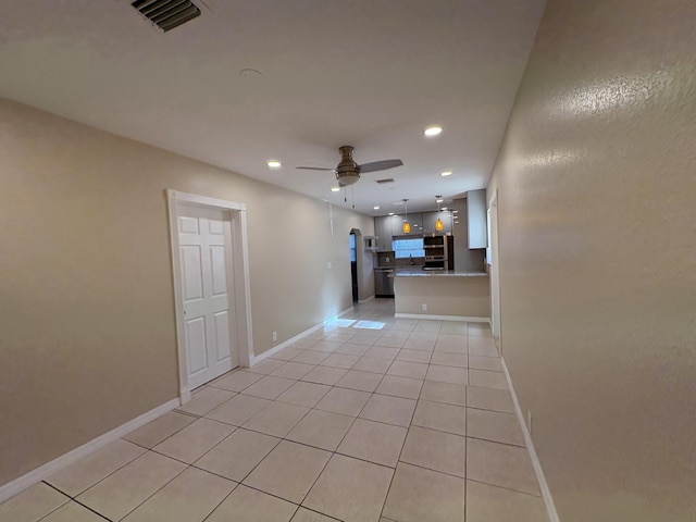 empty room featuring light tile patterned floors, recessed lighting, visible vents, and a ceiling fan