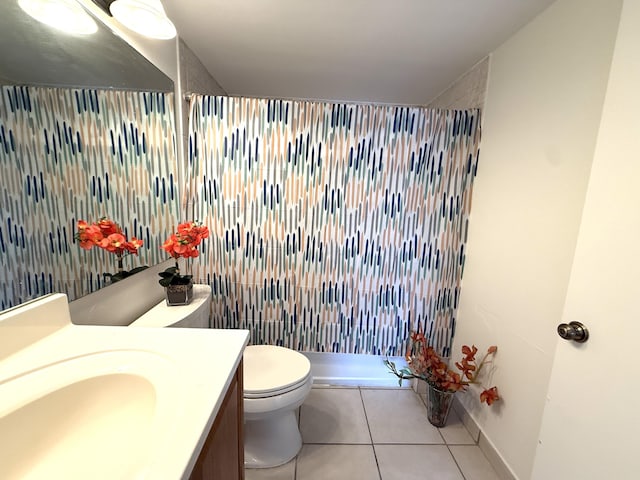 full bath with tile patterned flooring, a shower stall, vanity, toilet, and baseboards