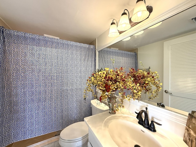 bathroom featuring toilet, a shower with curtain, and vanity