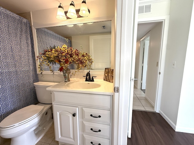 full bath featuring toilet, vanity, and wood finished floors