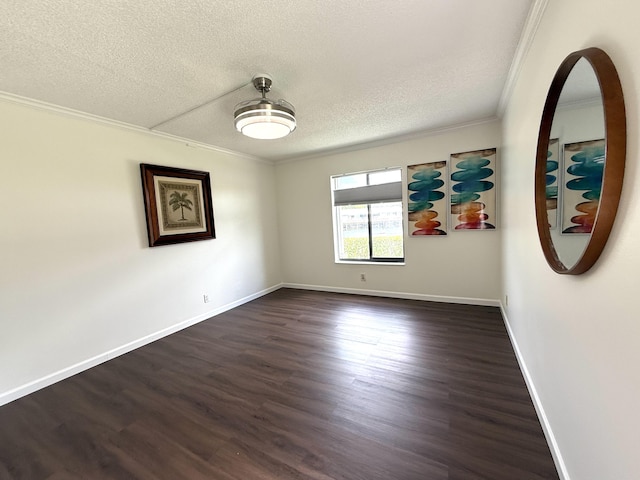 unfurnished room featuring ornamental molding, dark wood-type flooring, a textured ceiling, and baseboards