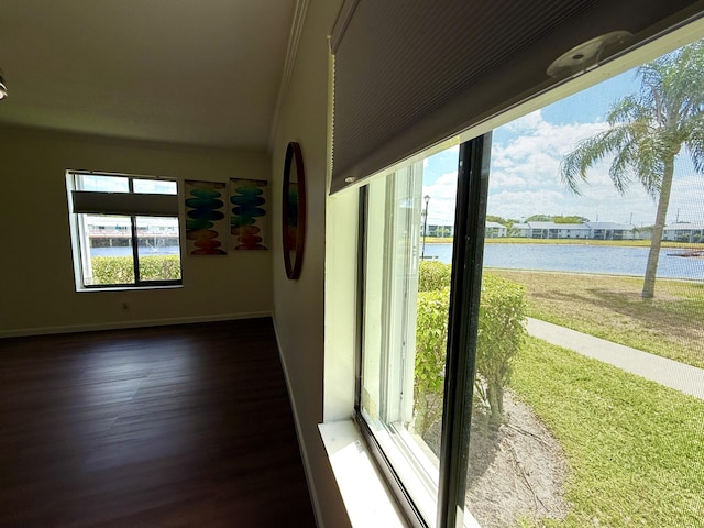 unfurnished sunroom featuring plenty of natural light and a water view