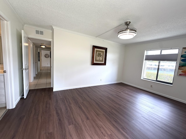 unfurnished room featuring ornamental molding, dark wood-style floors, a textured ceiling, and baseboards