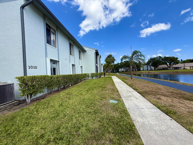 view of property's community featuring a water view and a yard
