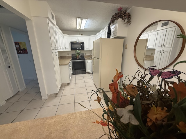 kitchen with black appliances, light tile patterned floors, white cabinetry, a textured ceiling, and light countertops
