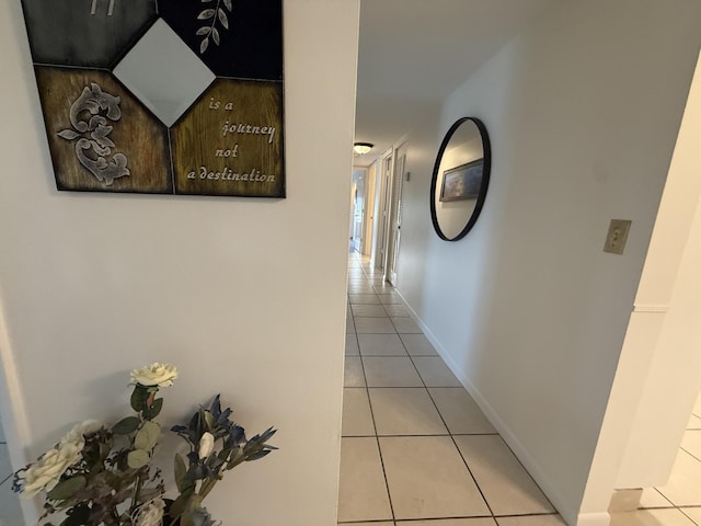 hall featuring light tile patterned floors