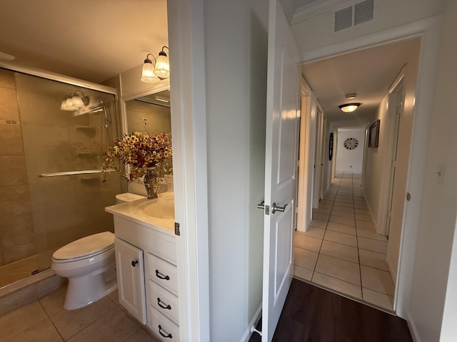 full bath featuring tile patterned flooring, a stall shower, vanity, and toilet
