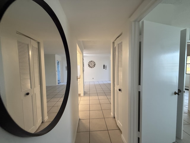 hall featuring light tile patterned floors