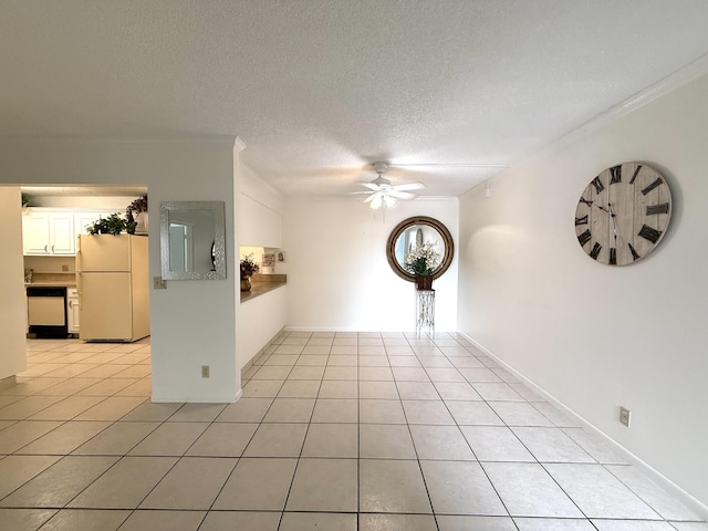 empty room with a ceiling fan, ornamental molding, light tile patterned floors, and a textured ceiling