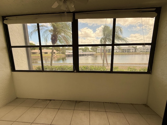 unfurnished sunroom featuring a water view