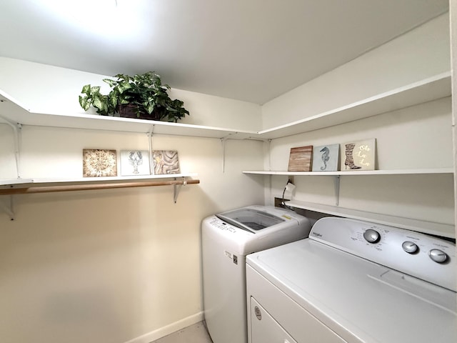 laundry area featuring washer and clothes dryer and baseboards