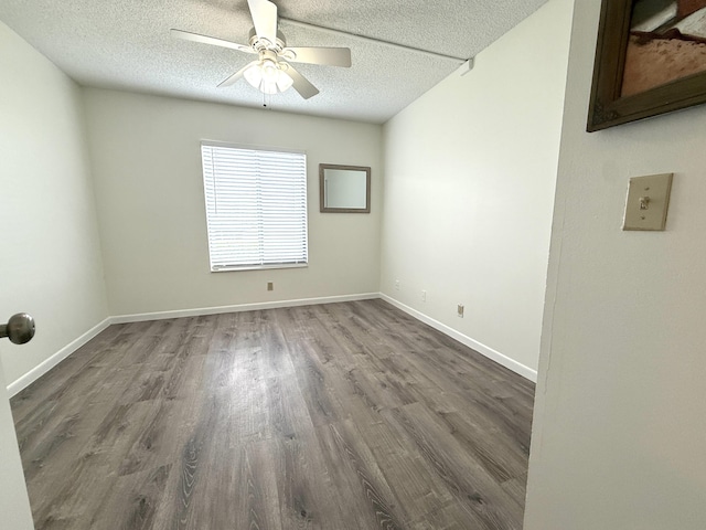 unfurnished room featuring wood finished floors, a textured ceiling, ceiling fan, and baseboards