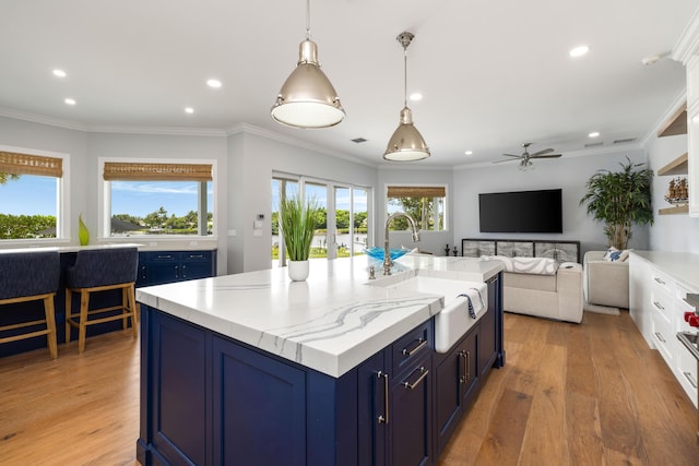 19100 SE County Line Rd, Jupiter, FL 33469 - kitchen with blue cabinetry, a sink, recessed lighting, a ceiling fan, and light wood finished floors