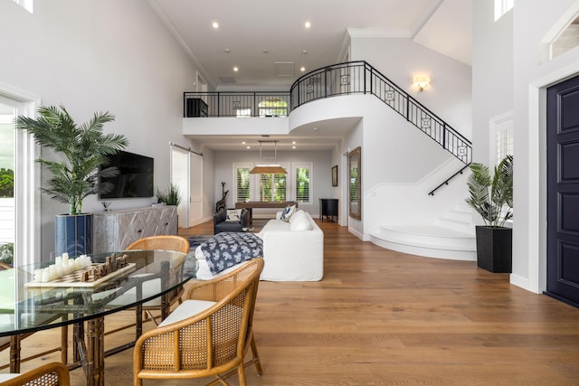19100 SE County Line Rd, Jupiter, FL 33469 - living room with a towering ceiling, wood finished floors, crown molding, stairway, and recessed lighting