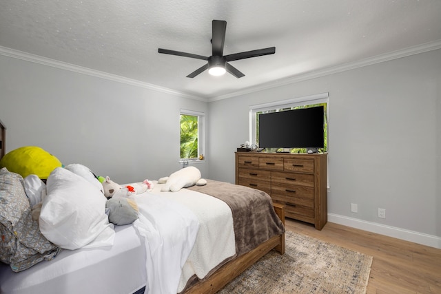 19100 SE County Line Rd, Jupiter, FL 33469 - bedroom with light wood finished floors, baseboards, crown molding, and a ceiling fan