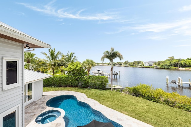 19100 SE County Line Rd, Jupiter, FL 33469 - view of swimming pool featuring a water view, a lawn, a patio, and a pool with connected hot tub