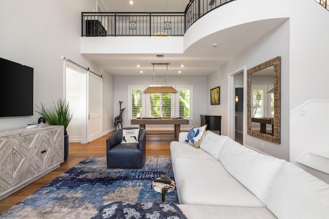 19100 SE County Line Rd, Jupiter, FL 33469 - living area with wood finished floors, a barn door, billiards table, a towering ceiling, and recessed lighting