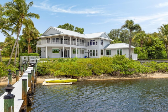19100 SE County Line Rd, Jupiter, FL 33469 - rear view of house with a balcony, a water view, and metal roof