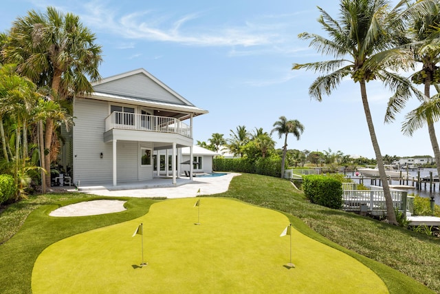 19100 SE County Line Rd, Jupiter, FL 33469 - back of property featuring a balcony, an area to practice putting, a patio, and an outdoor pool