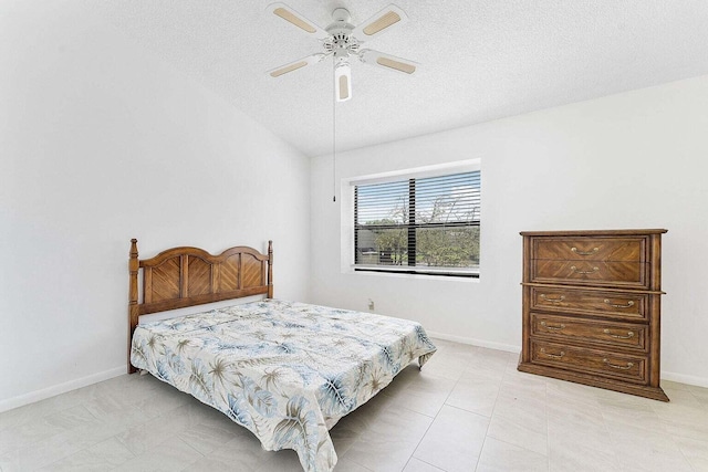 bedroom with baseboards, a ceiling fan, and a textured ceiling