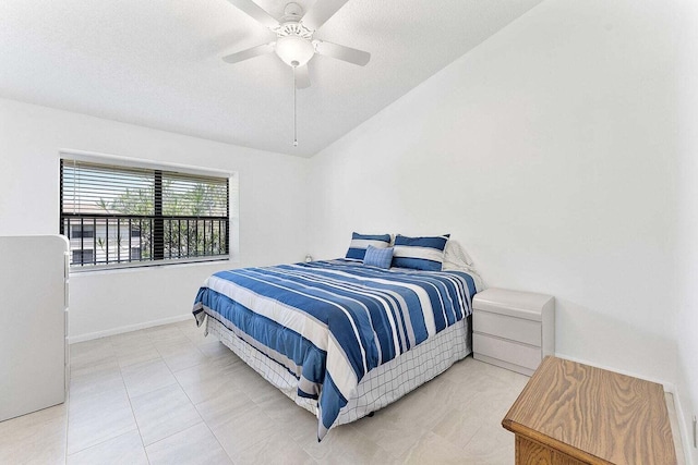 bedroom with a textured ceiling, ceiling fan, and baseboards