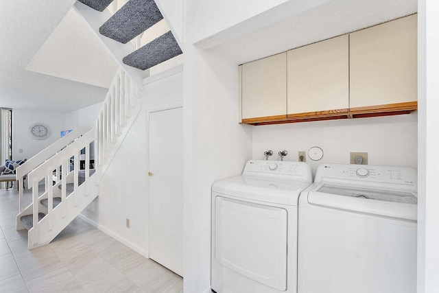laundry room with cabinet space and independent washer and dryer