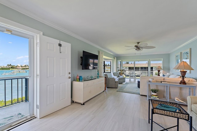 living area with crown molding, a water view, ceiling fan, and light wood-type flooring