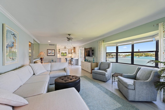 living area featuring ceiling fan, visible vents, wood finished floors, ornamental molding, and recessed lighting