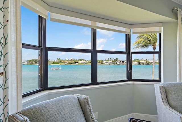 sunroom with a water view and a healthy amount of sunlight