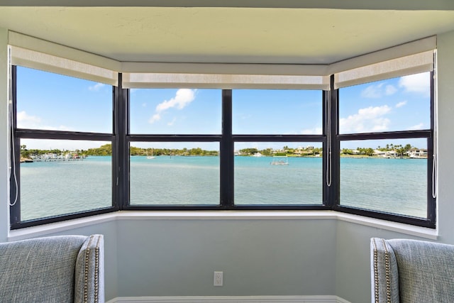 sunroom with a water view and a wealth of natural light