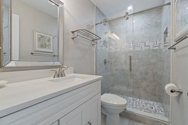 bathroom featuring vanity, toilet, and a shower stall