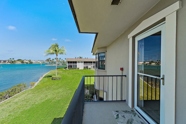balcony featuring a water view and visible vents