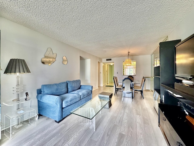 7145 Huntington Ln Unit 102, Delray Beach, FL 33446 - living room with light wood-style flooring, visible vents, and a textured ceiling
