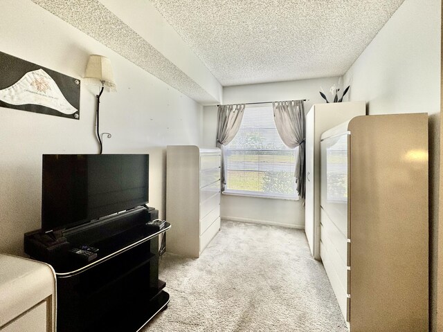 7145 Huntington Ln Unit 102, Delray Beach, FL 33446 - bedroom featuring a textured ceiling and carpet floors