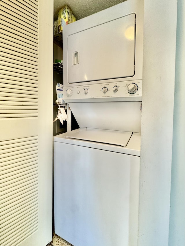 7145 Huntington Ln Unit 102, Delray Beach, FL 33446 - washroom featuring stacked washing maching and dryer and laundry area
