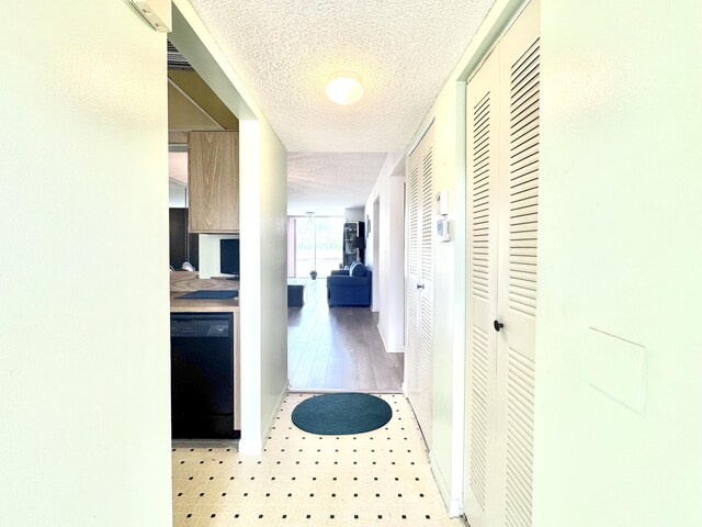7145 Huntington Ln Unit 102, Delray Beach, FL 33446 - corridor featuring light floors and a textured ceiling