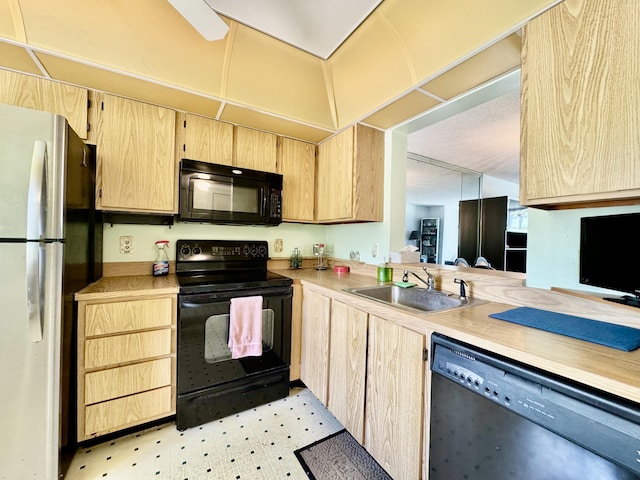 7145 Huntington Ln Unit 102, Delray Beach, FL 33446 - kitchen with a sink, light floors, black appliances, light countertops, and light brown cabinetry