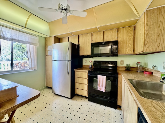 7145 Huntington Ln Unit 102, Delray Beach, FL 33446 - kitchen with a ceiling fan, light floors, baseboards, a sink, and black appliances
