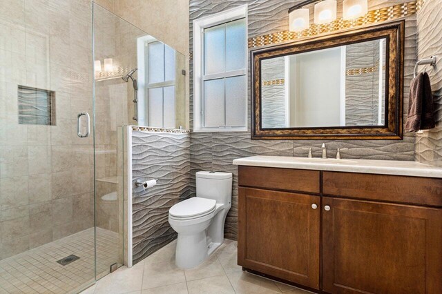 9481 Mcaneeny Ct, Wellington, FL 33414 - full bathroom with tile walls, a shower stall, tile patterned flooring, vanity, and toilet