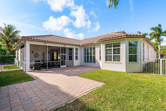 9481 Mcaneeny Ct, Wellington, FL 33414 - back of property with a sunroom, stucco siding, a tile roof, a patio area, and a ceiling fan